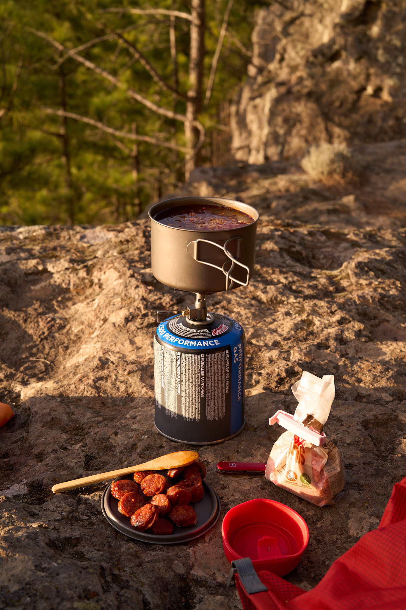 Camp cooking on a stove at golden hour on the rocky plateau.